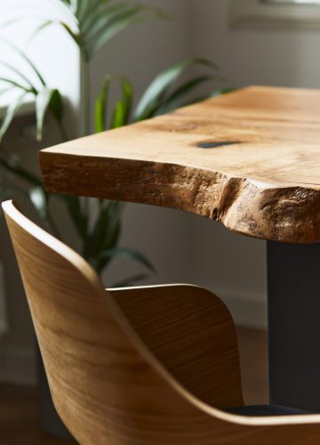 Stylish and cozy compositon of craft oak wooden table with chairs, plant and modern floor in beautiful interior of design home. Template.